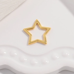 Detailed macro view of S925 sterling silver star shaped clasp with polished gold finish