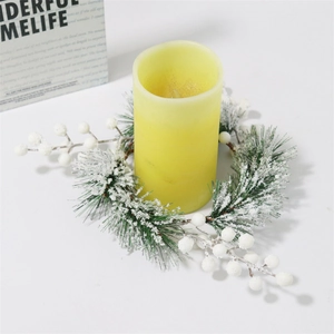 White snowy cedar pine needle candle ring wreath with white berries and yellow pillar candle