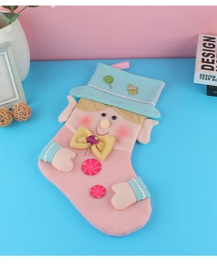 Detail of pink and blue knit Christmas stocking with cartoon elf and candy decorations