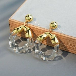 Elegant glass hoop earrings with gold metal studs on a minimalist textured display base