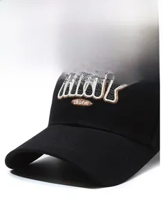 Close-up of black cotton baseball cap with MANY charm letter embroidery on structured brim