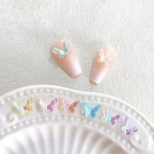 Holographic 3D resin butterfly nail charms on pink gradient false nails and ceramic tray