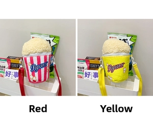 Detail of plush popcorn bucket crossbody bags in red and yellow with adjustable straps