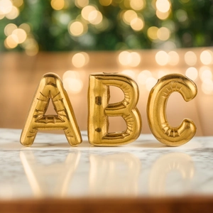 Golden 3D bubble letter A B C necklaces with metallic balloon texture on white marble