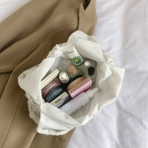 White lace makeup bag with large capacity shown in a stylish lifestyle setting