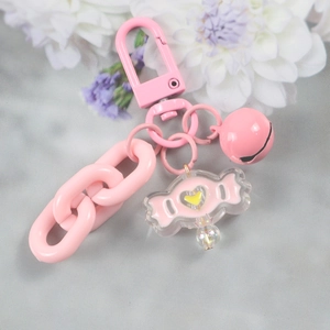 Close-up of pink D-ring keychain with acrylic candy pendant and thick link chain