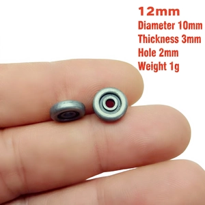 Detailed view of a 12mm silver metallic spacer bead held by hand for jewelry DIY