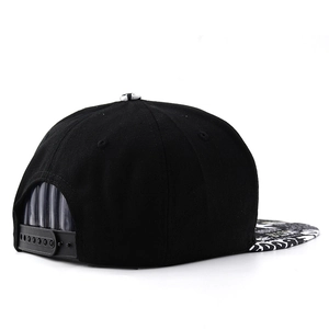 Detail of adjustable snapback closure and graffiti print brim on black hip-hop baseball cap