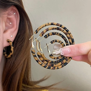 Detail view of leopard print hoop earrings in four different sizes for women