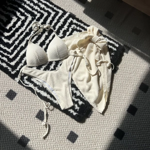 Three-piece beige waffle texture bikini set with halter top and matching beach sarong