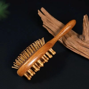 Detailed view of sandalwood massage comb with dual-sided fine teeth and thick pillars