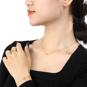 Golden cat paw jewelry set with necklace, bracelet and stud earrings on model