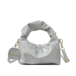 Silver metallic pleated handbag with adjustable shoulder strap and top handle design