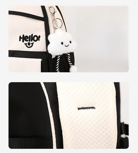 Detail view of contrast backpack showing plush cloud charm and breathable mesh straps