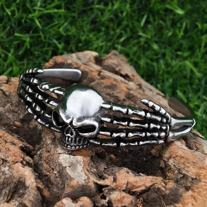 Skull bone cuff bracelet in stainless steel with vintage silver finish on wood