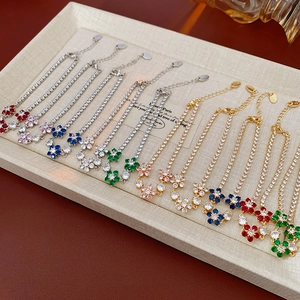 Macro shot of assorted flower bracelets featuring colorful cubic zirconia and lobster clasps