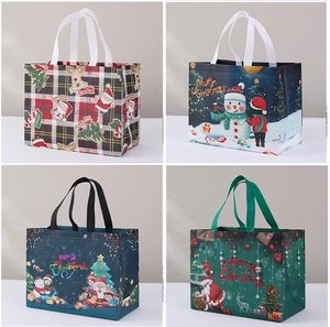 Close-up of non-woven Christmas gift bags featuring four festive cartoon patterns