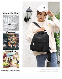Detail of a black nylon backpack with a front zipper pocket and side pouches for daily travel