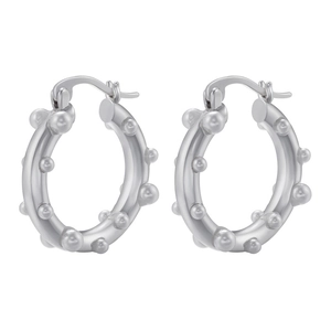 Minimalist silver brass hoop earrings with irregular bead decoration shown on a grey background