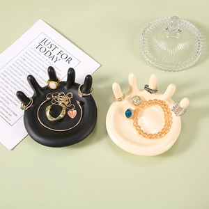 Palm shaped resin jewelry tray in black and white for rings and necklace storage