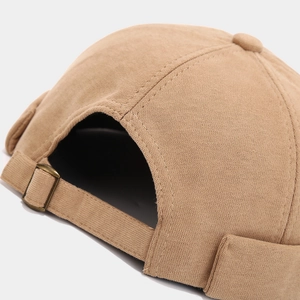 Close-up of khaki docker hat adjustable strap and metallic buckle detail