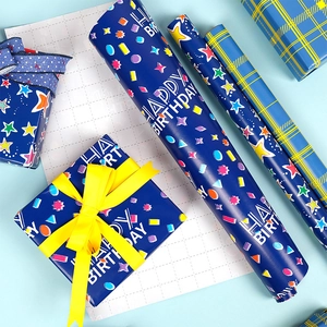 Detail of dark blue Happy Birthday gift wrap roll with stars and yellow ribbon accent