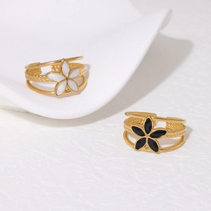 Detail of floral enamel rings with triple-layer cutout bands in gold and white finish