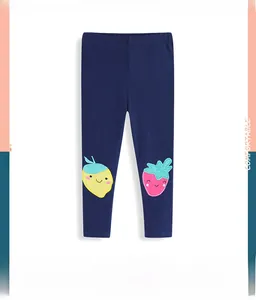 Detail view of navy blue girls leggings featuring cute lemon and strawberry embroidery