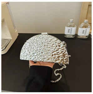 Detailed view of silver hammered metal crescent evening clutch bag with chain strap