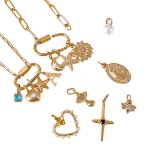 Gold stainless steel necklace with various DIY charms like heart, cross, and moon pendants