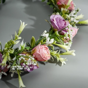 Close-up of handmade pink and purple silk roses on a floral bridal headband