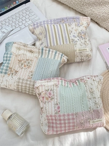 Set of floral quilted cotton makeup bags in purple, blue, and pink pastel colors