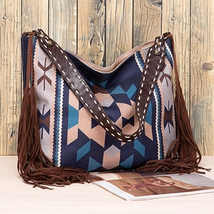 Detail of bohemian hobo bag with geometric patterns, long tassels and leather shoulder strap
