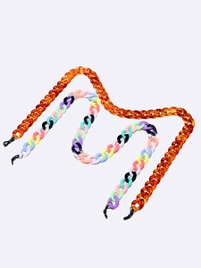 Macro detail of acrylic eyewear chains in amber marble and colorful candy link designs
