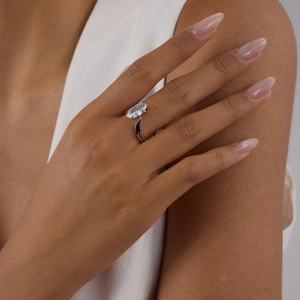 Silver stainless steel ring with marquise cut zircon on model hand in natural light