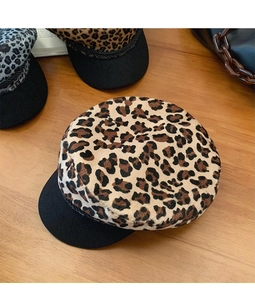 Detailed look at brown and grey leopard print newsboy caps with sleek black brims