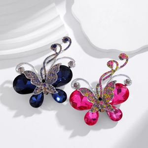 Elegant butterfly brooches with vibrant blue and pink faceted crystals on a silver base