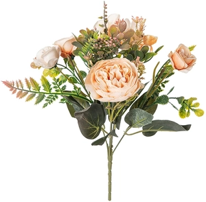 Champagne and apricot artificial ranunculus bouquet with green fern leaves on white backdrop