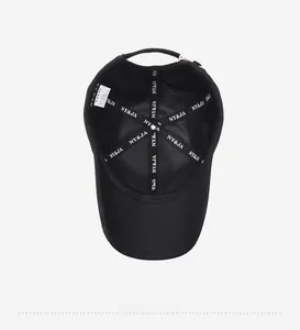 Detail view of the black baseball cap interior with NY&JA branded tape and stitching