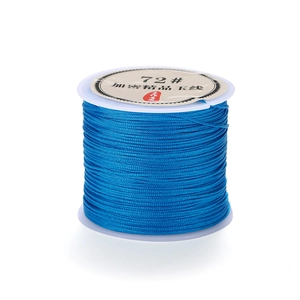 Macro shot of 0.8mm navy blue polyester braided cord on a white plastic spool