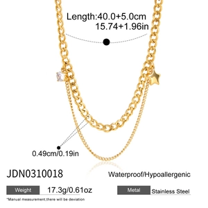 Detail of gold double-layer necklace with star pendant and zircon on cuban chain link