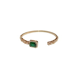 Elegant gold open bangle with square emerald gemstone and sparkling zircon accents
