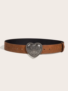 Detail of vintage brown paisley embossed leather belt with ornate silver heart buckle