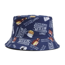 Close-up detail of dark blue tie-dye bucket hat featuring vintage beer theme prints