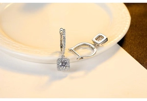 Macro detail of S925 sterling silver square hoop earrings with sparkling pave zircon settings