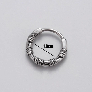 Detailed macro view of 1.0cm antique silver hoop earring with barbed wire pattern