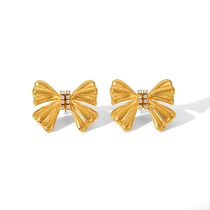 Macro shot of 18K gold plated bow earrings featuring sparkling crystal rhinestones
