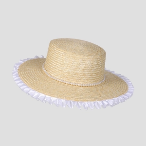 Close-up of woven straw sun hat with delicate white lace trim and pearl bead detailing