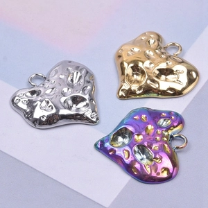 Irregular heart pendants in gold silver and rainbow finish with textured metal surface