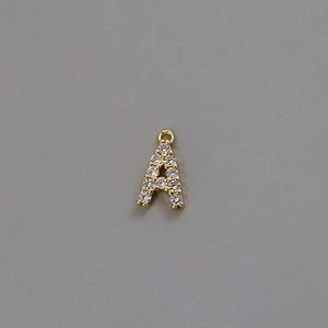 Detail of 18k gold plated letter A pendant with shimmering cubic zirconia inlay
